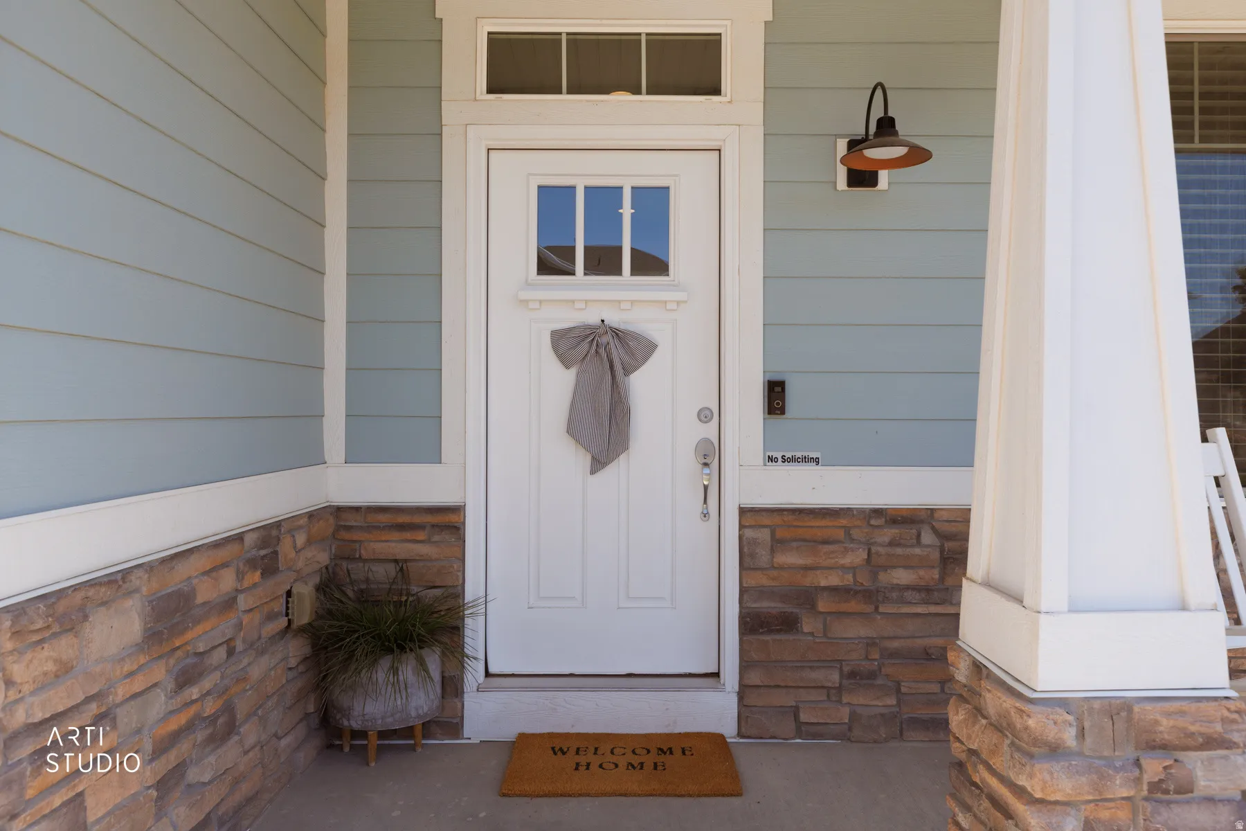 Entryway featuring a white paneled door with window inserts and a transom window