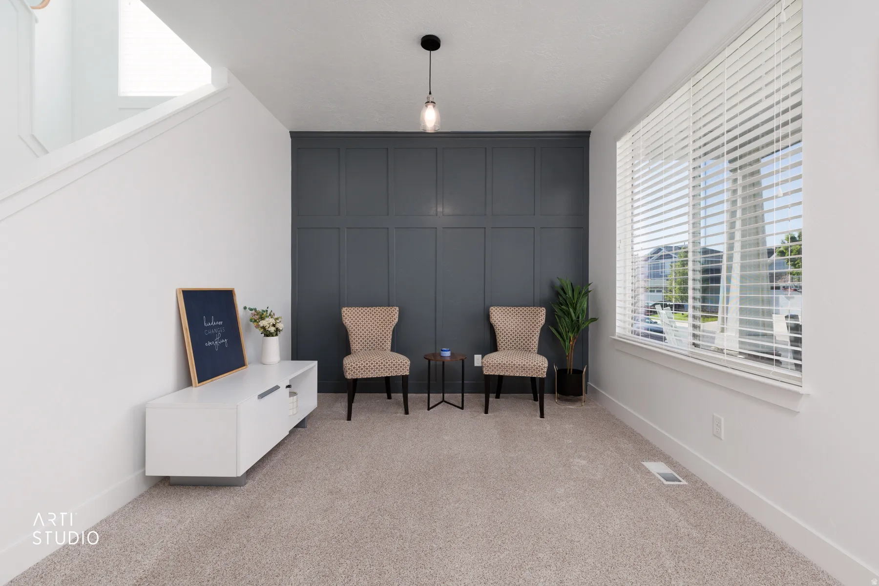 Accent wall with board and batten detailing and a contemporary pendant light
