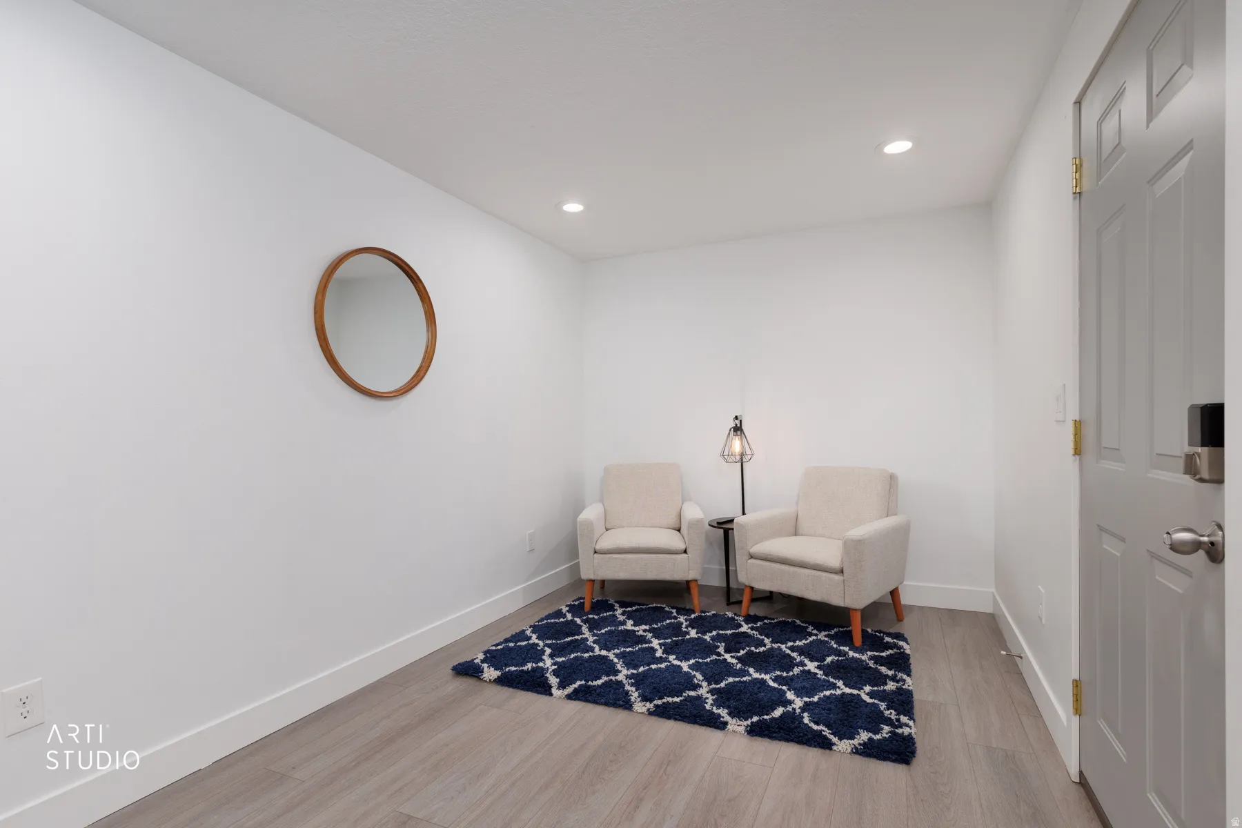 Versatile room featuring light wood-finish flooring, white walls, and recessed lighting