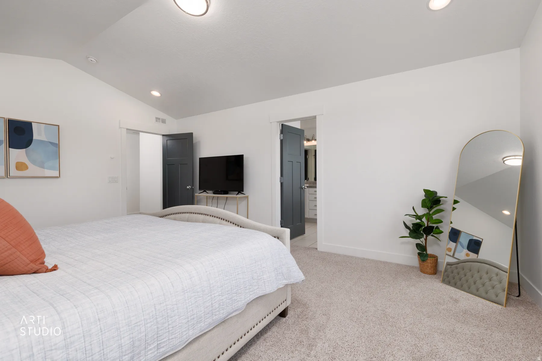 Vaulted ceiling with recessed lighting and a contemporary ceiling fixture