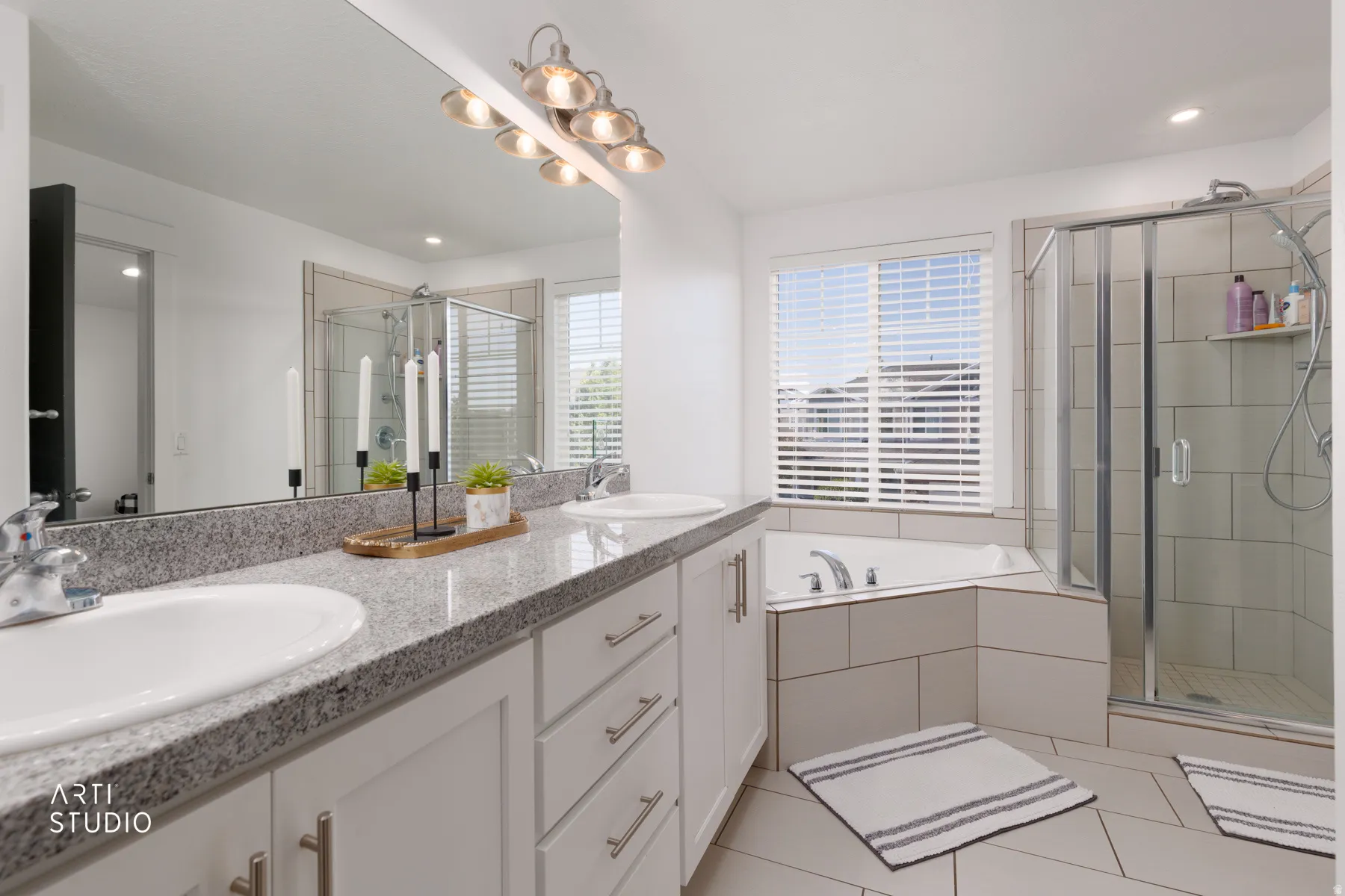 Dual vanity with stone-finish countertop, undermount sinks, and ample cabinetry