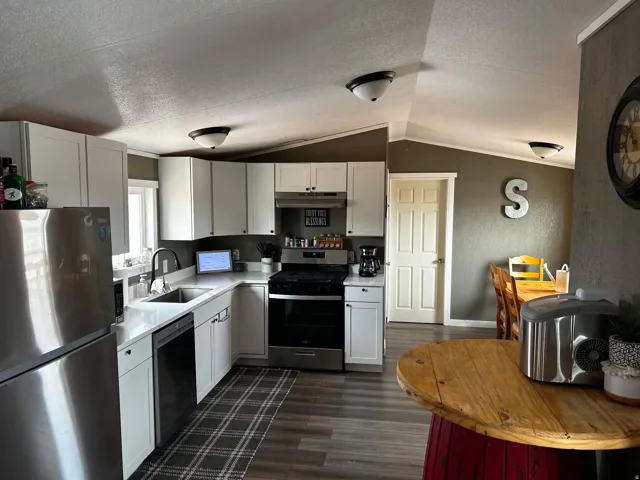 Modern kitchen featuring white cabinetry and stainless steel appliances