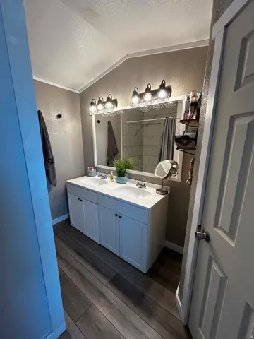 Master Double vanity with white cabinetry, integrated sinks, and chrome faucets