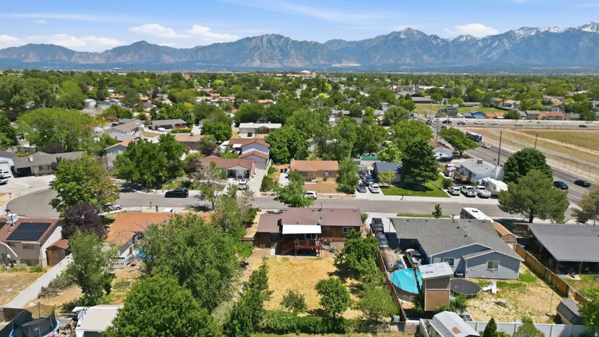 Overhead perspective showcasing a residential neighborhood with a distant mountain range backdrop