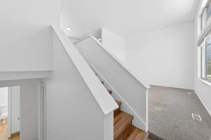 Modern staircase with wood-finish treads and white risers