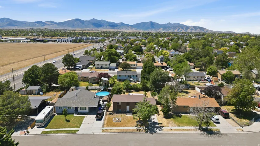 Aerial perspective showcasing a residential neighborhood with distant mountain scenery