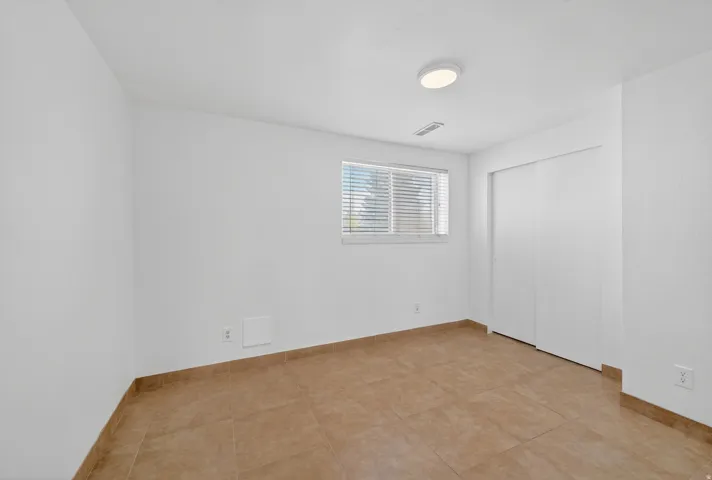 Neutral-toned tile flooring with matching base trim