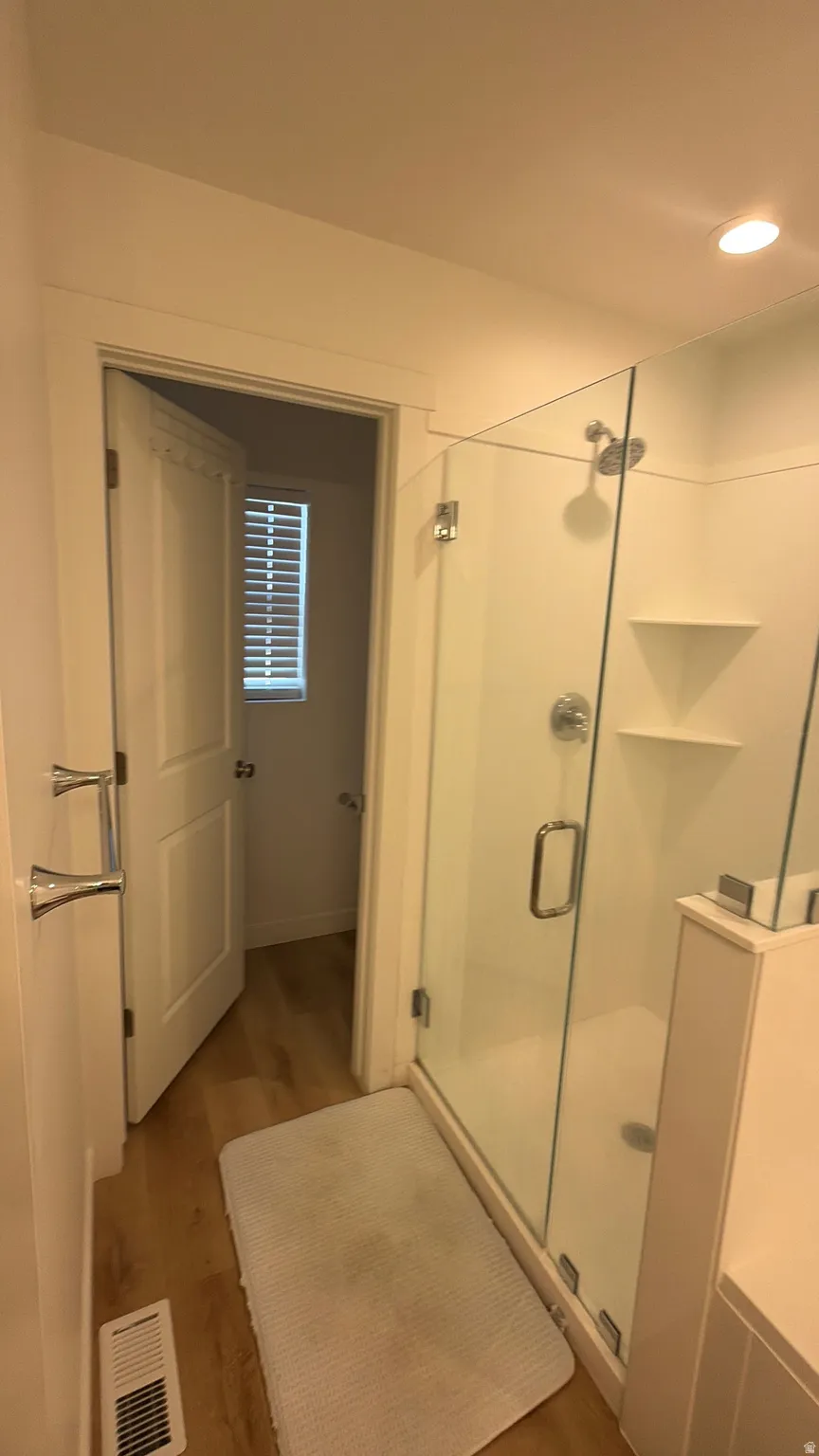 Walk-in shower with clear glass enclosure and chrome fixtures