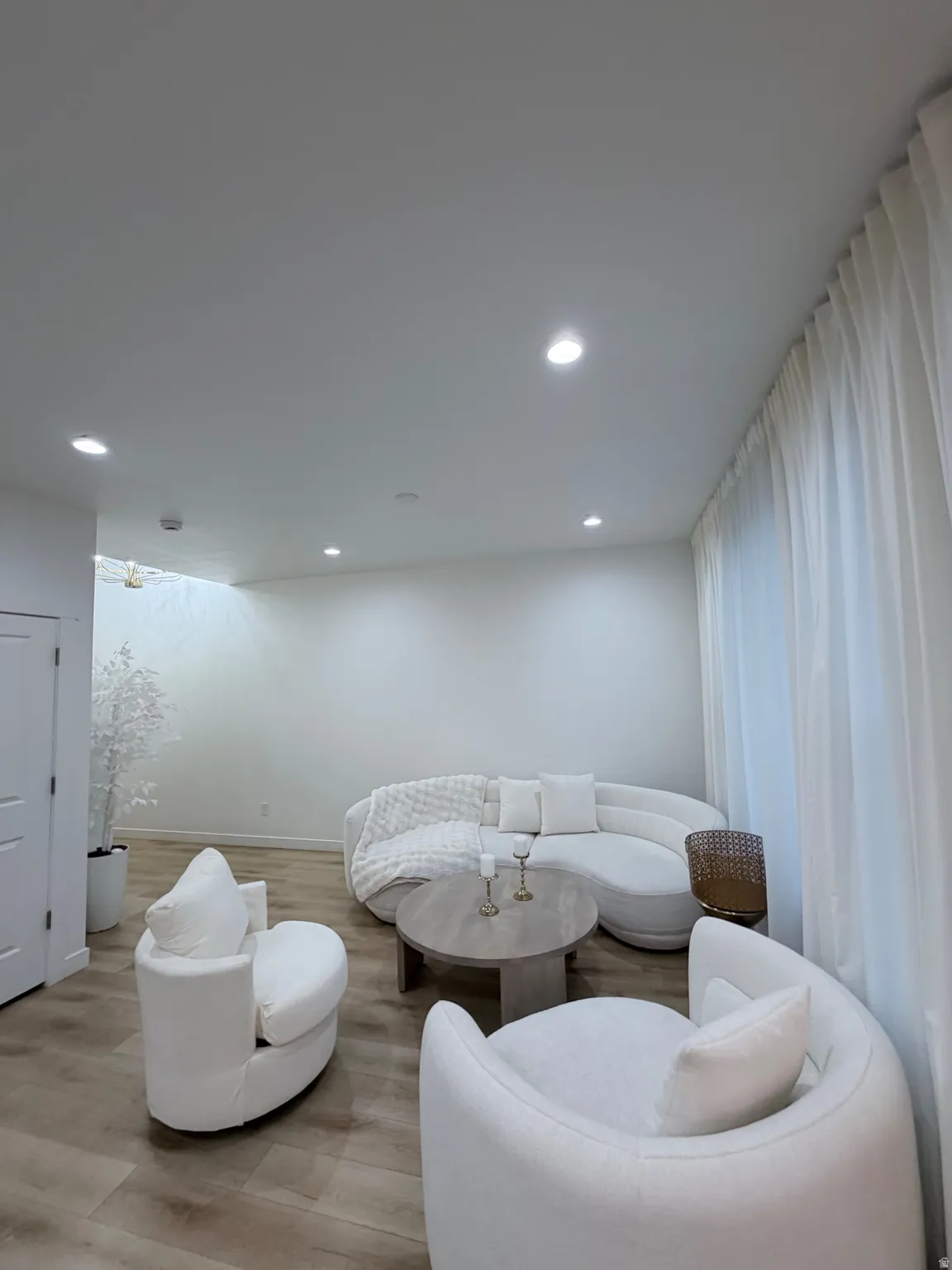 Spacious room with recessed lighting and light wood-finish flooring