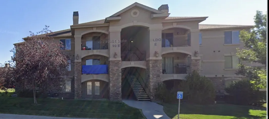 Multi-story building featuring stucco and stone veneer facade