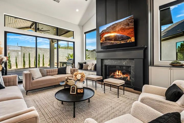 Living area featuring a modern fireplace with a dark mantel and stone surround