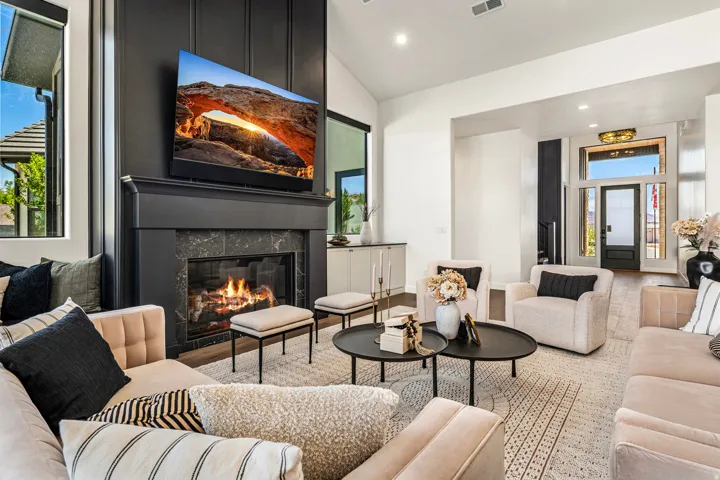Living area featuring a black fireplace with a mantel, dark stone surround, and a paneled accent wall