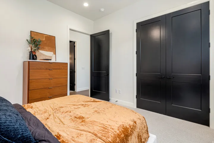 Room featuring light-toned carpeting, white walls, and recessed lighting