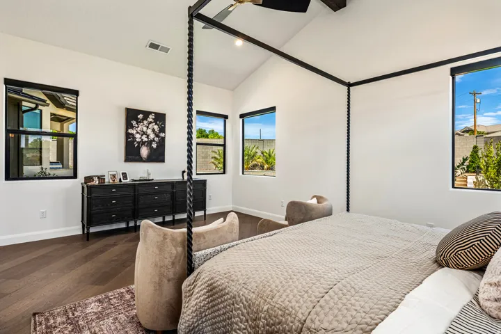Vaulted ceiling room with wood-finish flooring
