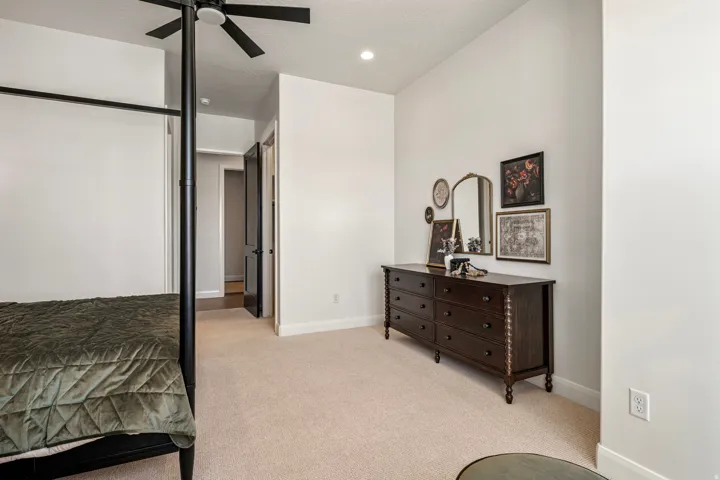 Neutral tone walls with recessed lighting and a ceiling fan