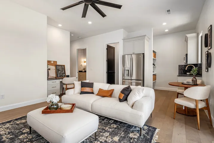Open-concept living area featuring wood-finish flooring, recessed lighting, and a ceiling fan