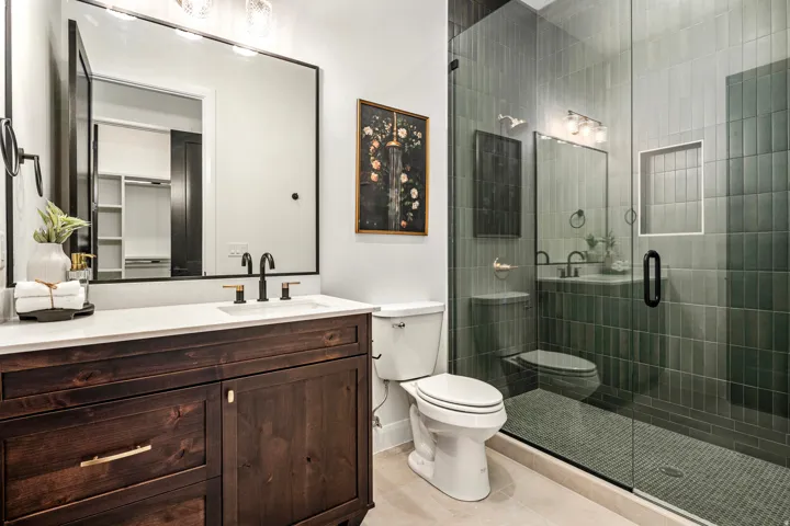 Contemporary bathroom featuring a dark wood-finish vanity with a white countertop and rectangular sink