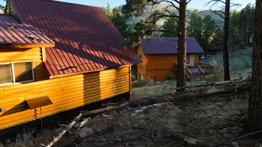 Log-style exterior with a metal roof and a visible window