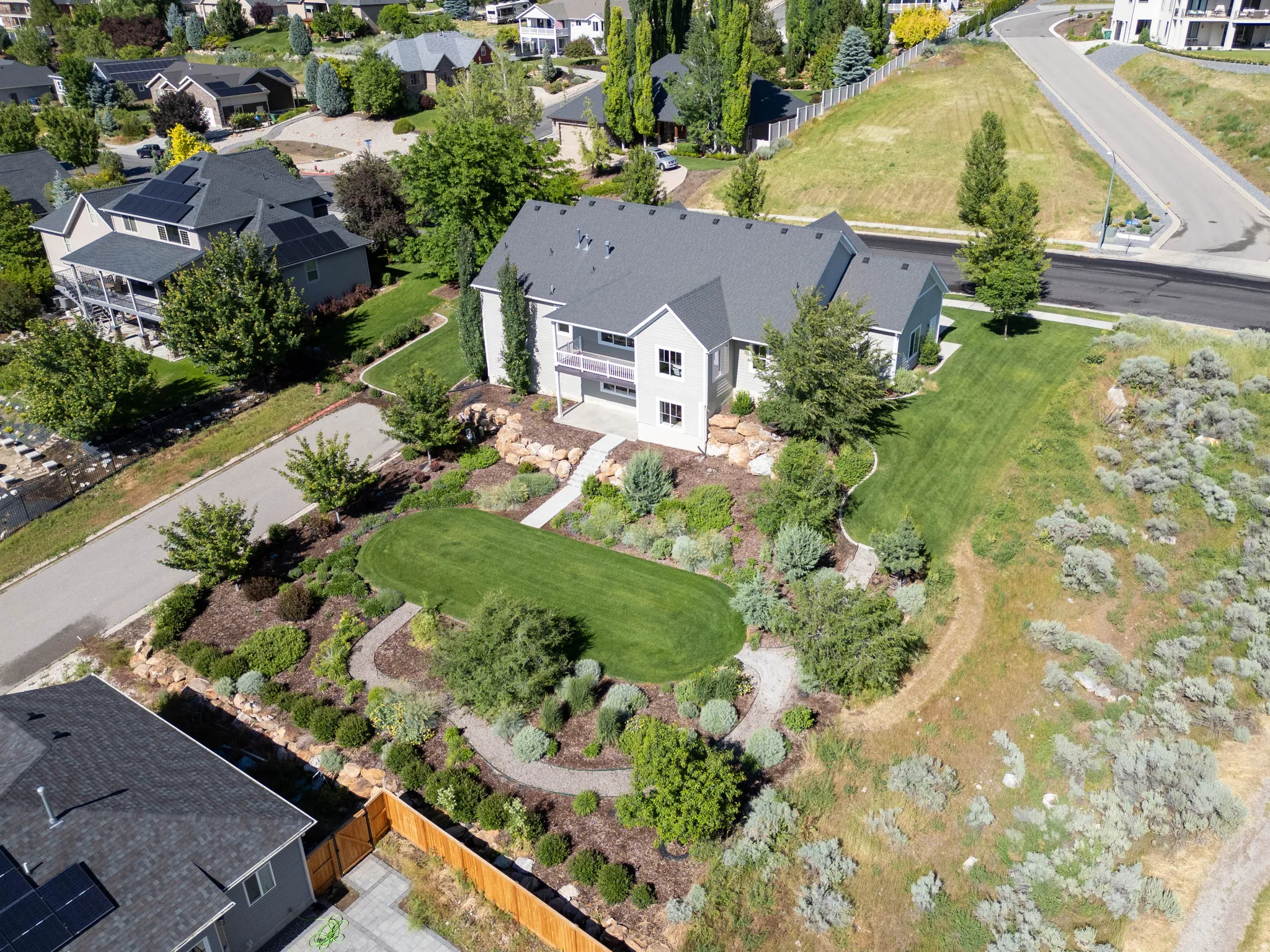 Spacious residence featuring a multi-level design and a dark shingled roof