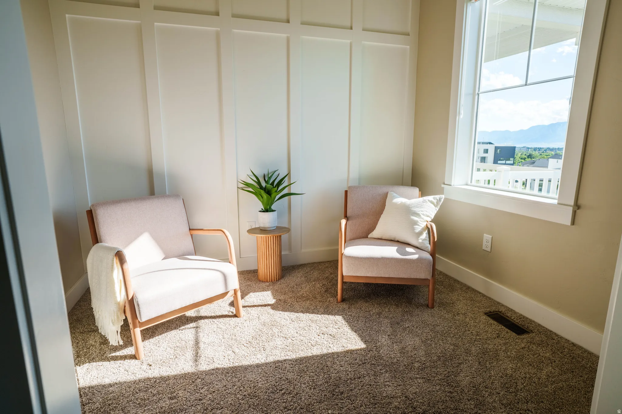 Board and batten accent wall complementing a large window with mountain scenery
