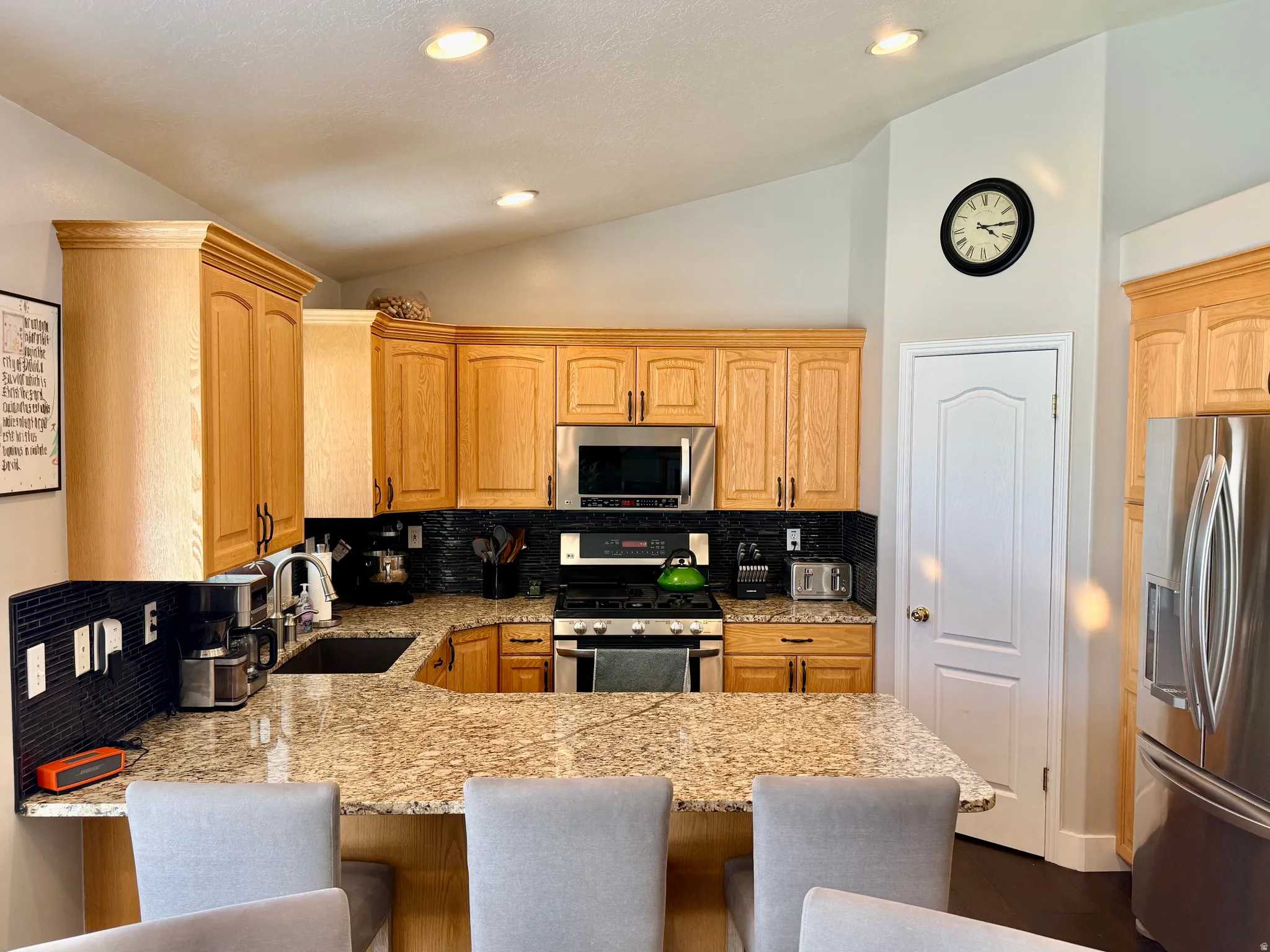 Kitchen featuring wood cabinetry, granite countertops, and stainless steel appliances