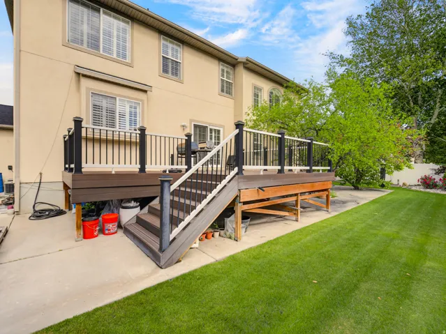 Multi-level deck with composite wood-finish decking and integrated railing system