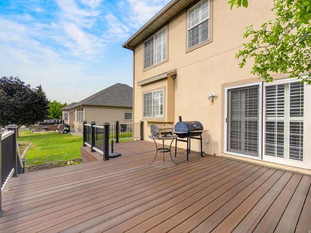 Expansive composite deck featuring a multi-tone wood-finish surface and black metal railings