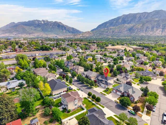 Aerial perspective showcasing a residential neighborhood with a prominent mountain range backdrop