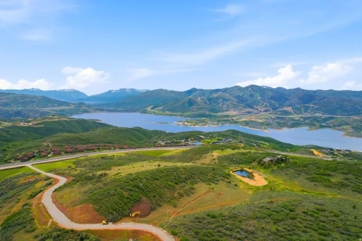 Expansive green hillsides featuring a winding paved road
