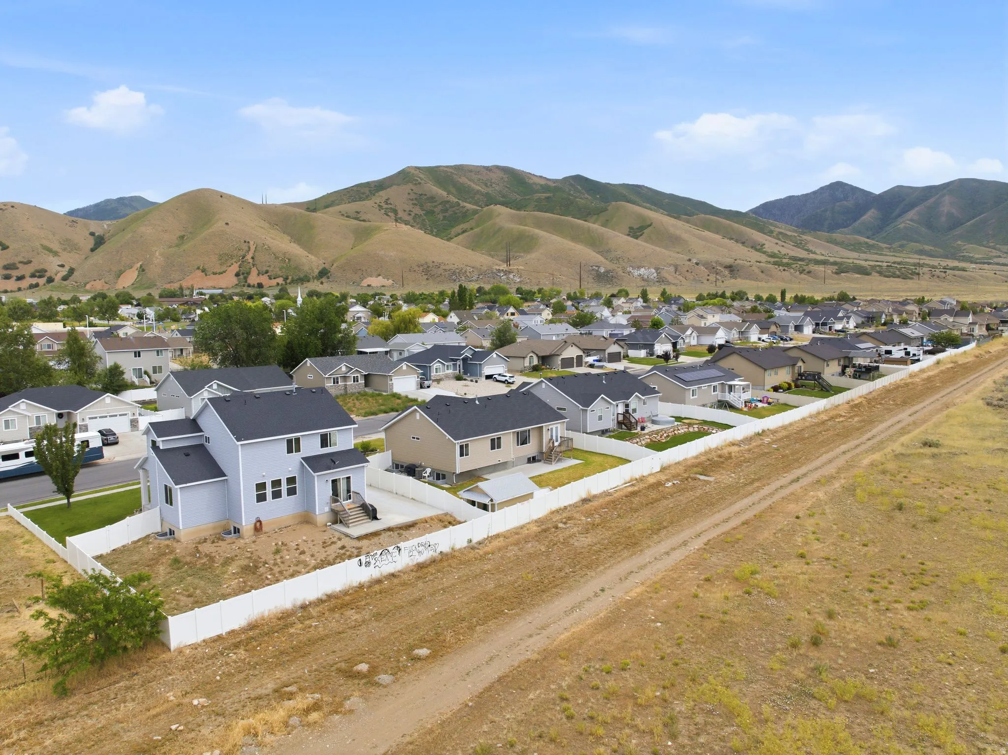 Expansive suburban neighborhood featuring a variety of residential structures with mountain backdrops