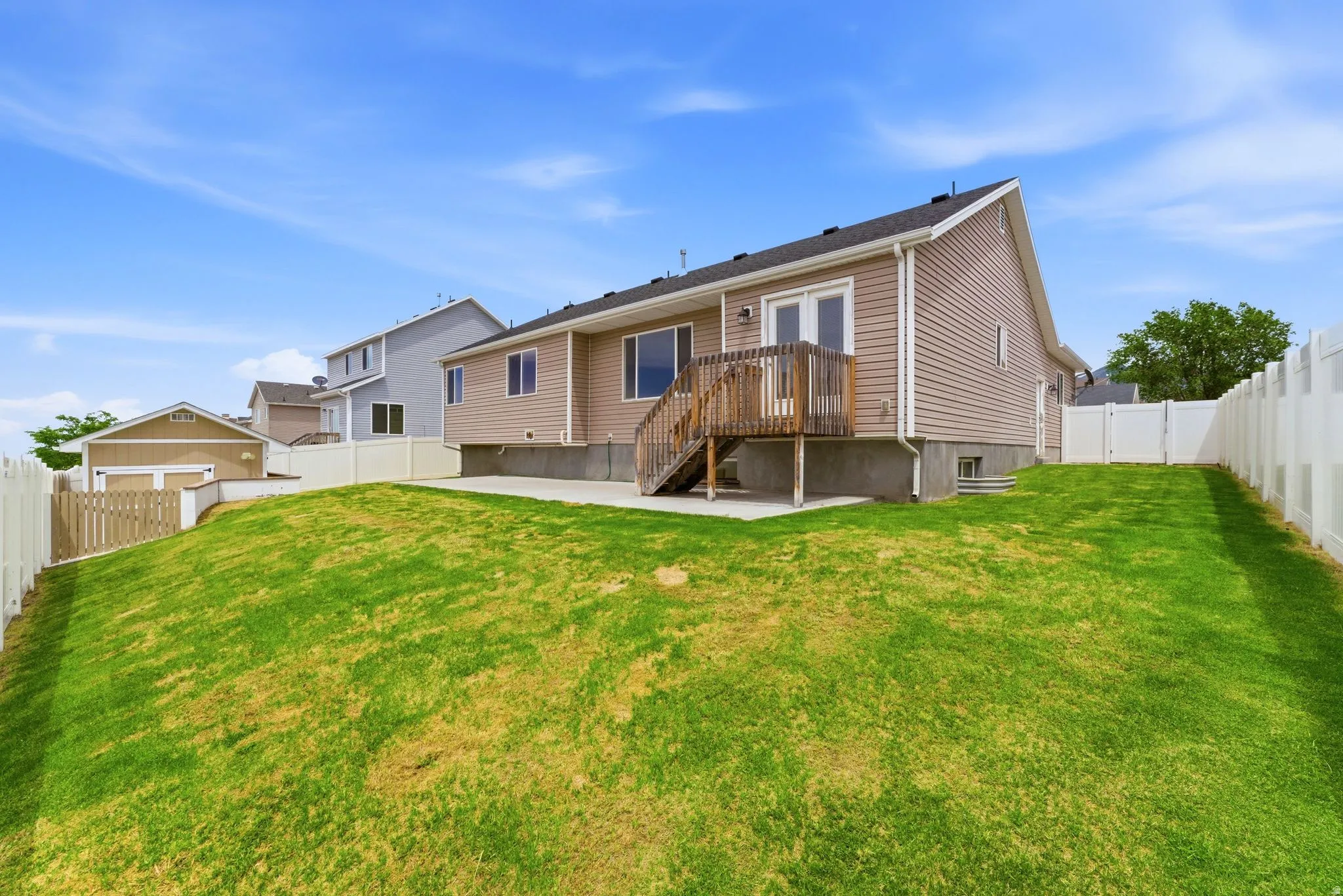 Expansive green lawn with vinyl fencing