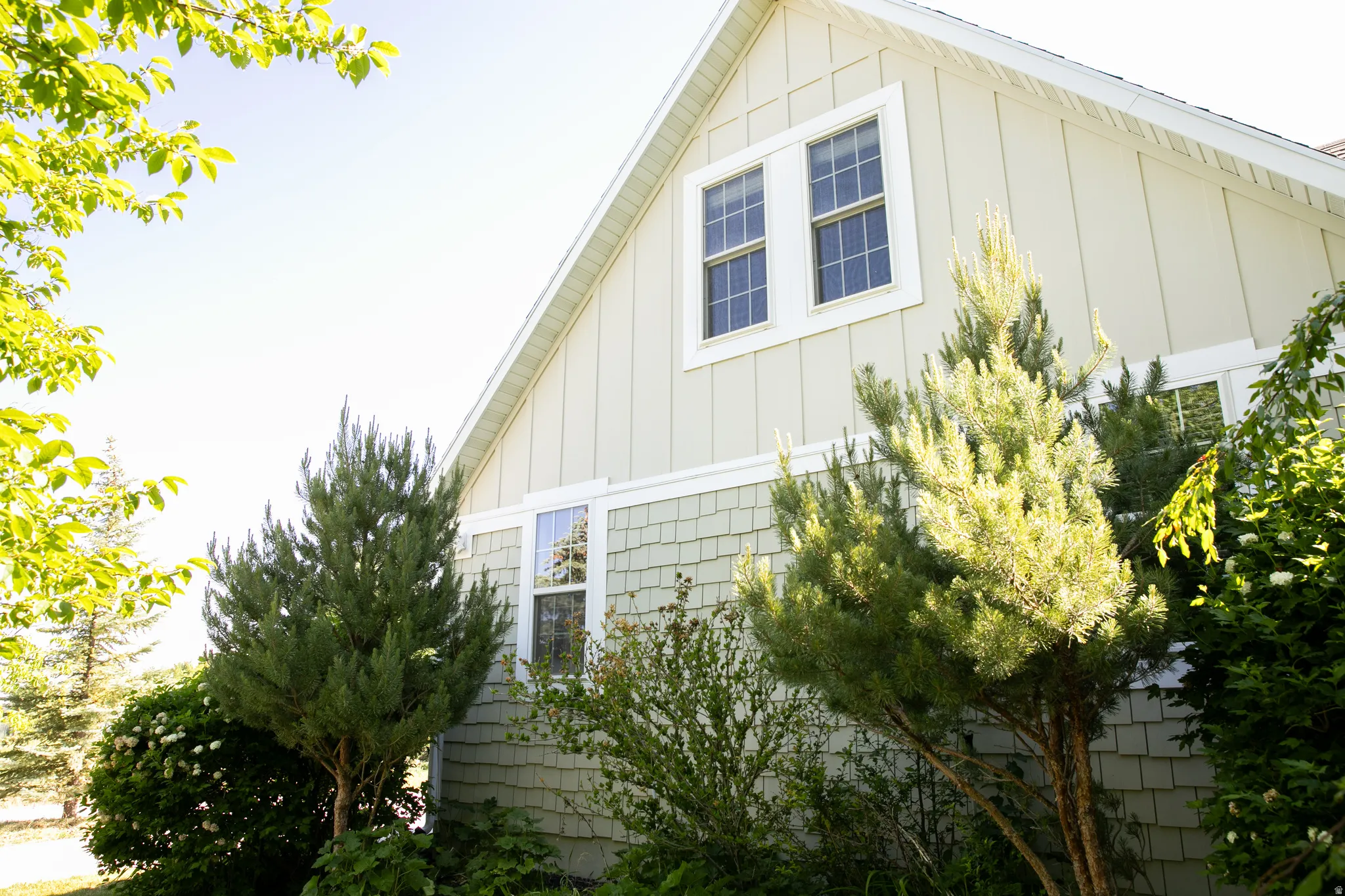 Exterior facade featuring board and batten siding with contrasting shingle accents