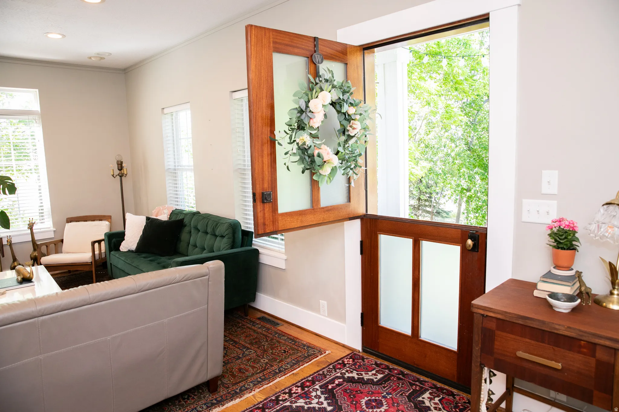 Dutch door entry featuring wood paneling and opaque glass inserts