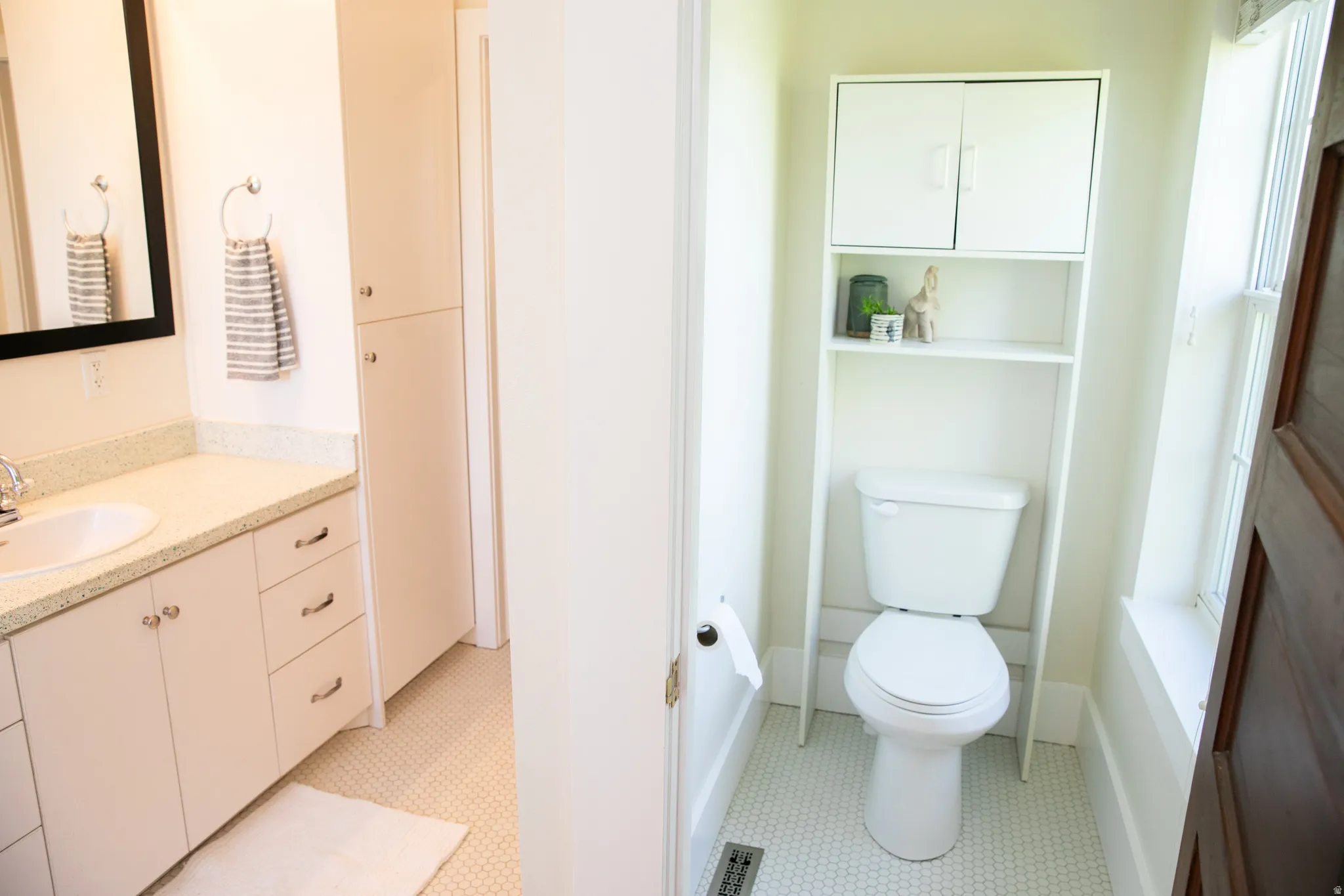 Bathroom featuring a white vanity with an integrated sink, light-colored countertop, and storage cabinetry