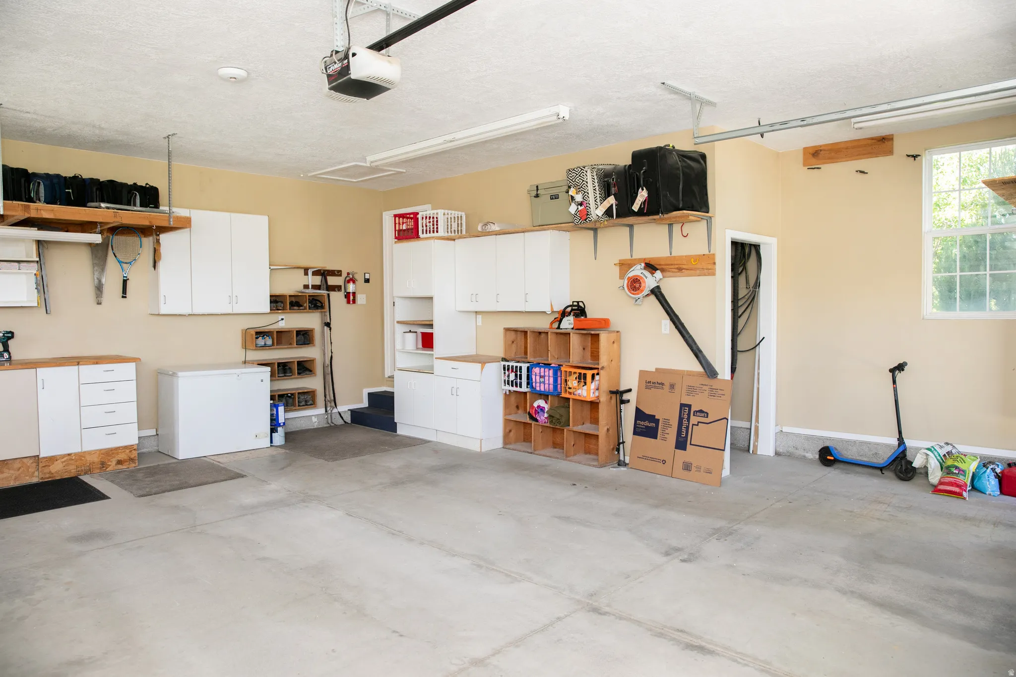 Spacious garage featuring concrete flooring and ample overhead lighting