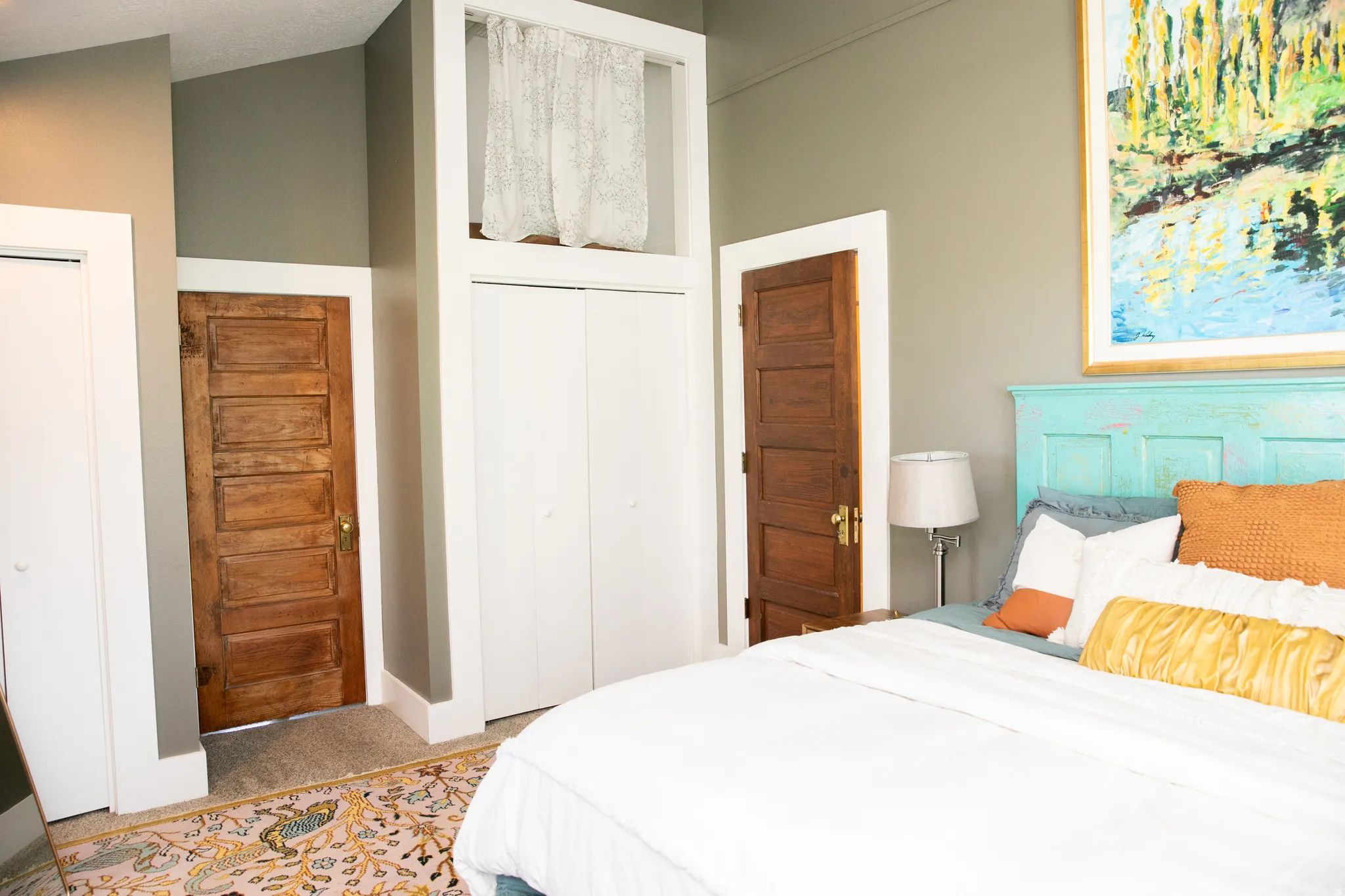 Bedroom featuring a paneled wood door and white bi-fold closet doors