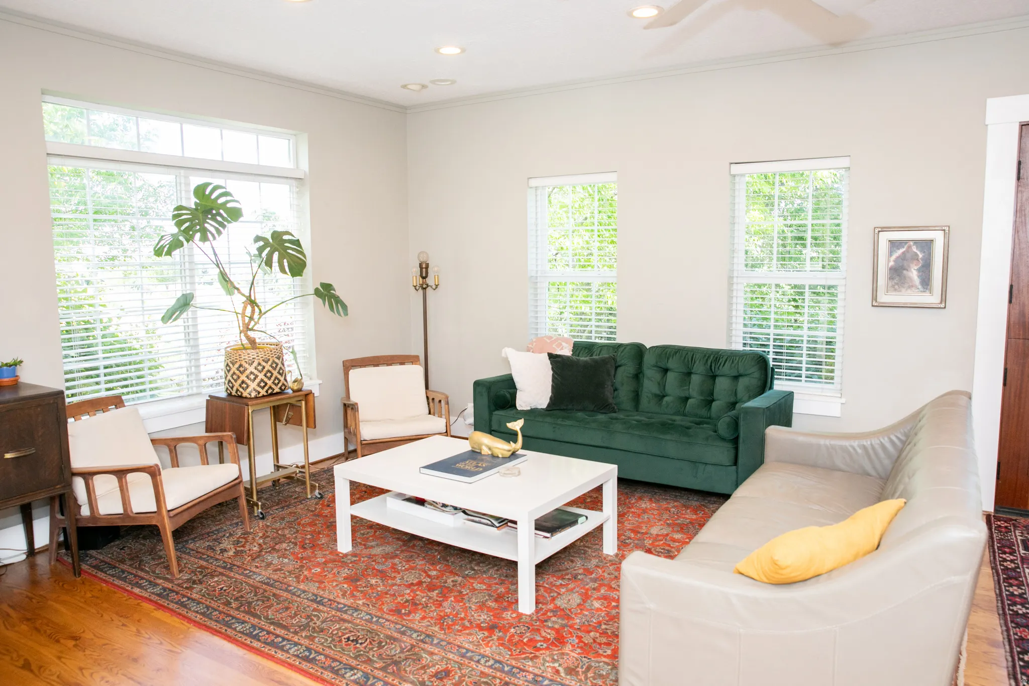 Living area featuring multiple windows with blinds, wood-finish flooring, and recessed lighting