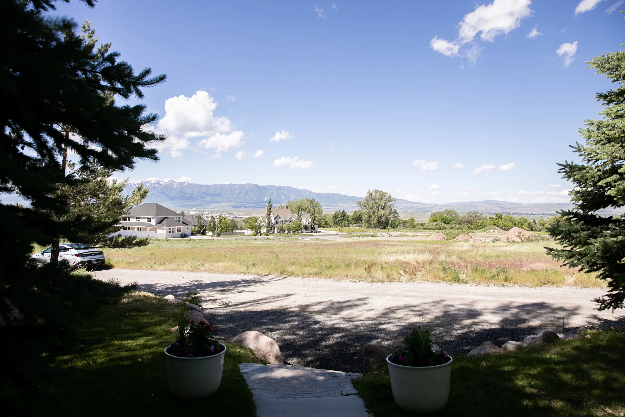 Distant mountain range backdrop with partial snowcaps, surrounded by expansive undeveloped land
