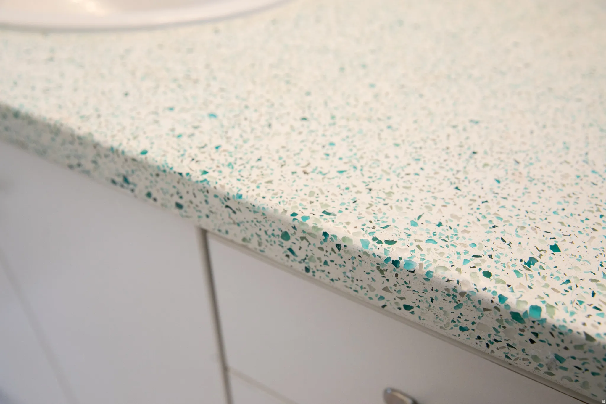 White countertop featuring blue and green aggregate detailing