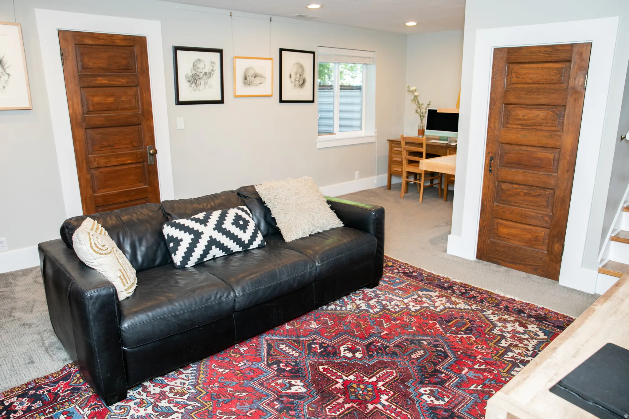 Spacious room featuring light-toned walls and recessed lighting