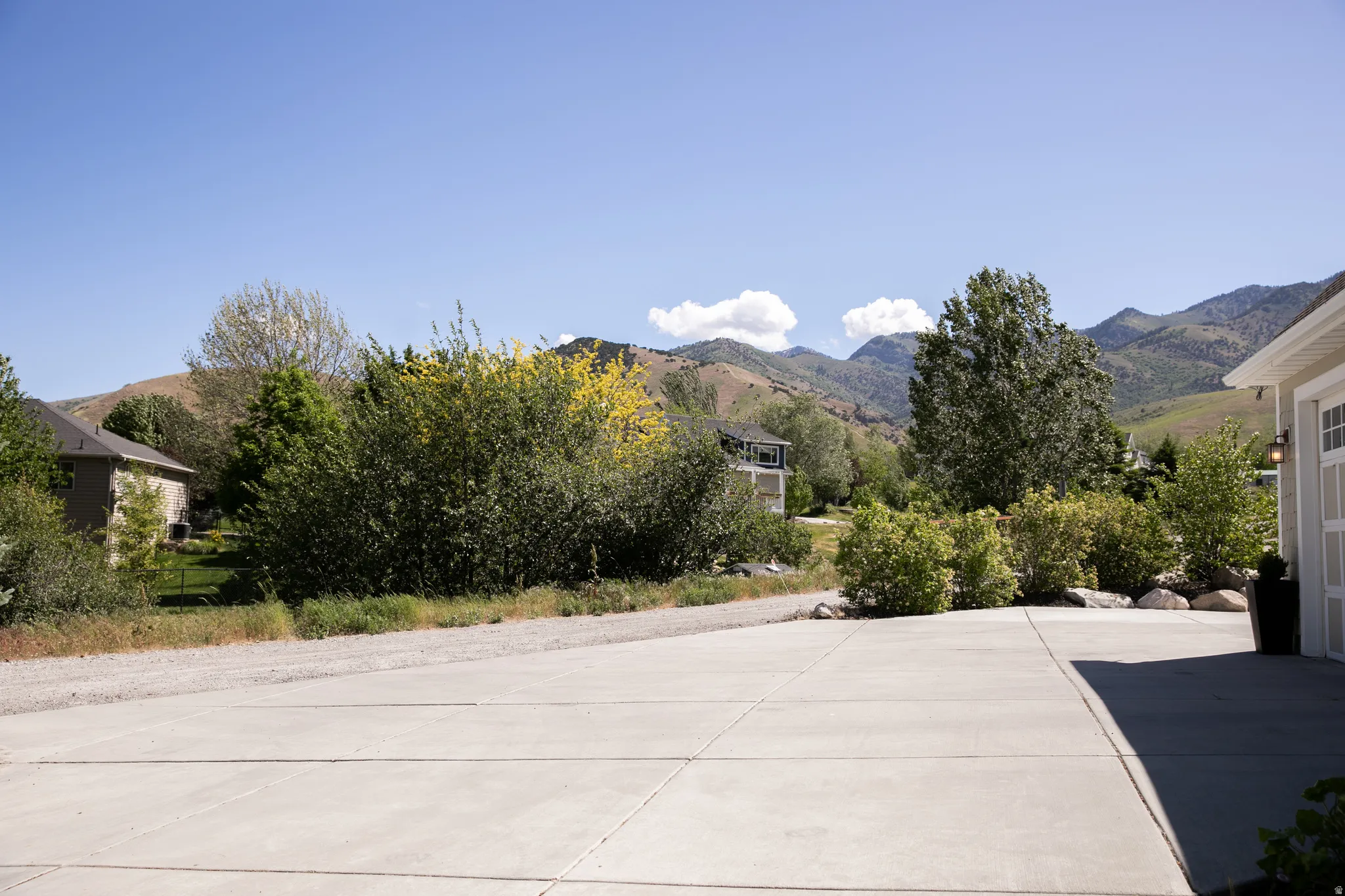 Expansive concrete driveway with mountain scenery beyond