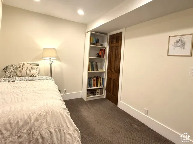 Bedroom #4 with recessed lighting, and a wood-paneled door