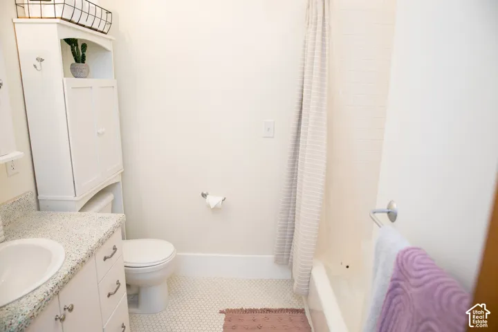 Level two full bathroom featuring a white vanity with a speckled countertop and an undermount sink
