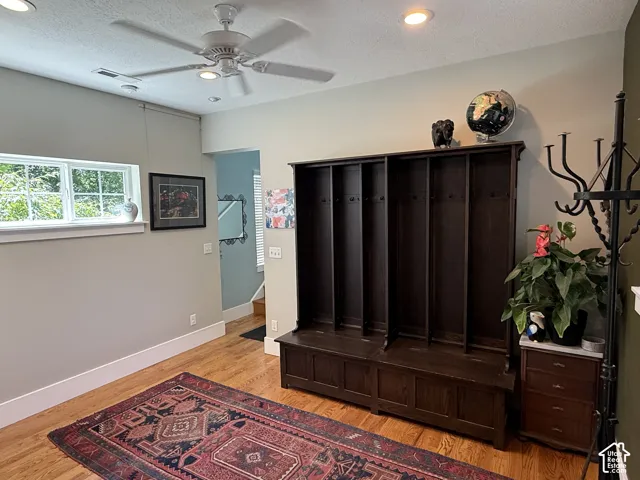 Main floor mudroom with hardwood flooring, recessed lighting, and a ceiling fan.
