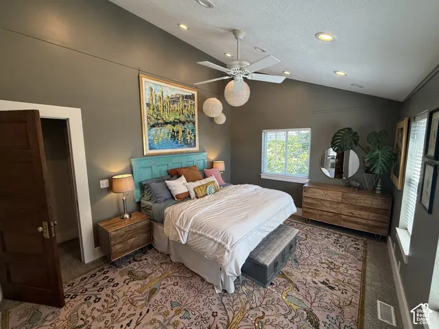 Primary Bedroom with vaulted ceilings, ceiling fan, and recessed lighting.
