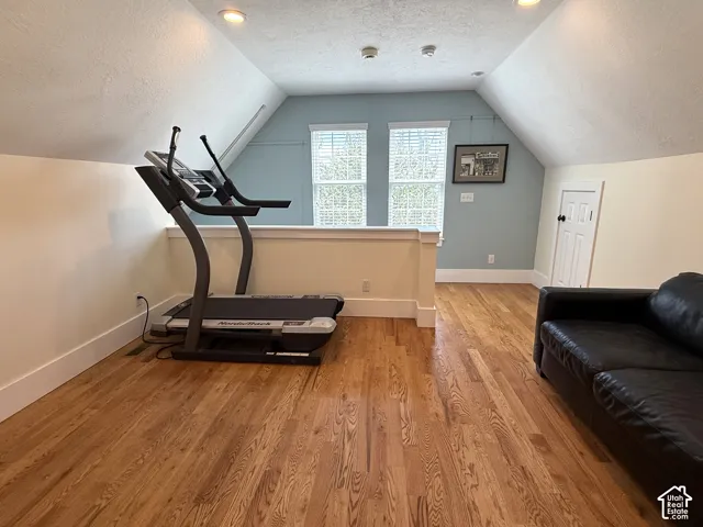 Above garage flex/bonus room, featuring wood-finish flooring, recessed lighting