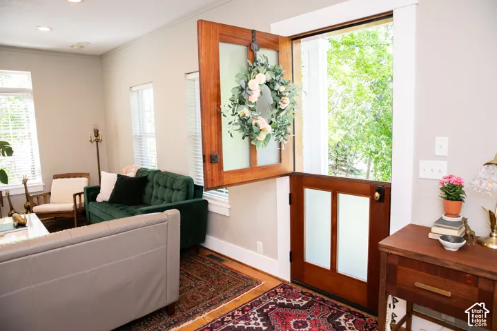 Dutch door entry featuring wood paneling and opaque glass inserts