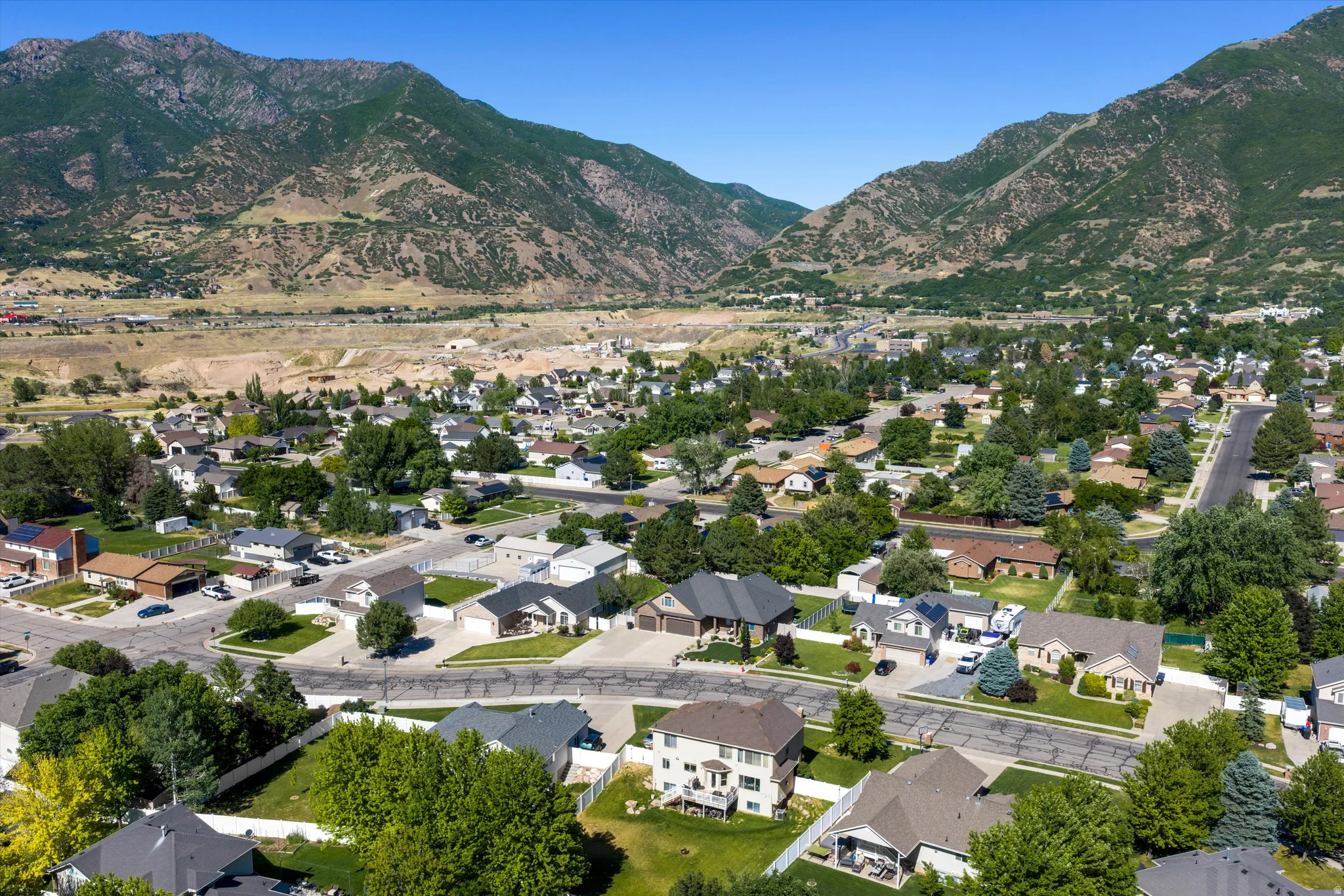 Aerial perspective showcasing a residential area with varied home styles and mature trees
