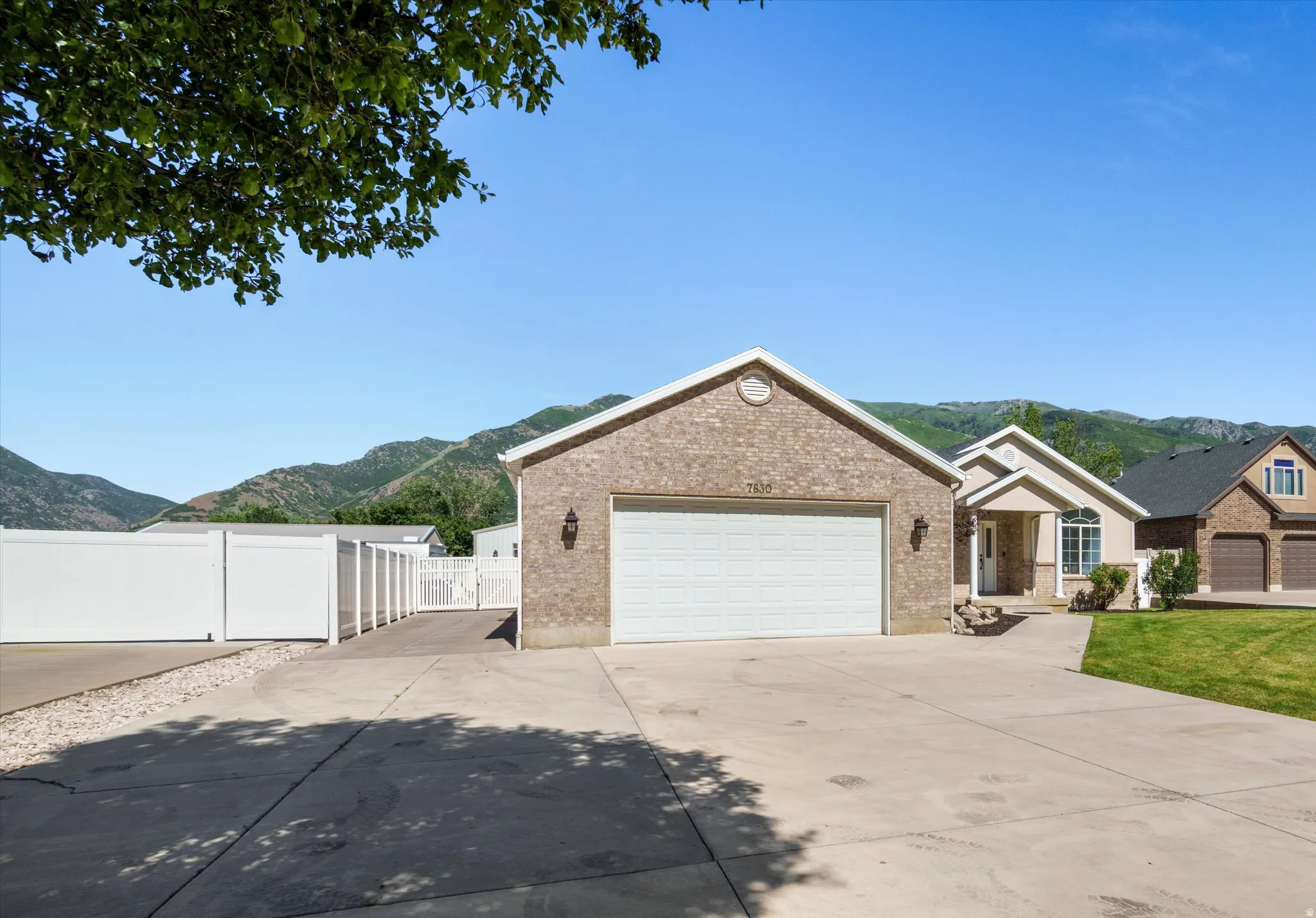 Brick Rambler two car garage with RV Drive to shop