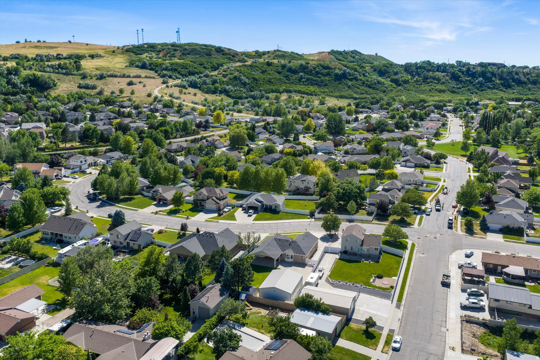 Expansive residential neighborhood featuring numerous single-family homes with pitched roofs, mature trees, and landscaped yards